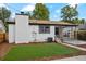Landscaped backyard with artificial turf and detached garage at 4643 S Cherokee St, Englewood, CO 80110