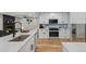 Modern kitchen with white cabinets and a large island at 4643 S Cherokee St, Englewood, CO 80110