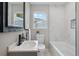 Updated bathroom with a bathtub, marble tile, and a modern vanity at 4643 S Cherokee St, Englewood, CO 80110