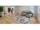 Light and airy living room with hardwood floors, open to kitchen at 4643 S Cherokee St, Englewood, CO 80110