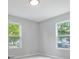 Bright bedroom with neutral walls, new carpet, and two large windows at 4643 S Cherokee St, Englewood, CO 80110