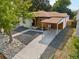 Modern home exterior with carport, gravel landscaping, and walkway at 4643 S Cherokee St, Englewood, CO 80110