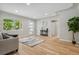 Open concept living room with hardwood floors and large windows at 4643 S Cherokee St, Englewood, CO 80110