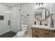 Modern bathroom with a glass shower, marble tile, and a floating vanity at 4643 S Cherokee St, Englewood, CO 80110
