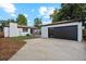 Modern detached garage with dark gray door and windows at 4643 S Cherokee St, Englewood, CO 80110
