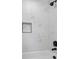 Clean shower with white marble-look tile and a built-in niche at 4643 S Cherokee St, Englewood, CO 80110