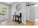 Light and bright entryway with console table and hardwood floors at 4643 S Cherokee St, Englewood, CO 80110