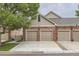 Two-car attached garage with additional parking at 9833 Greensview Cir, Lone Tree, CO 80124