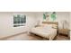 Bright bedroom with large window, plush bedding, and wooden nightstands at , Aurora, CO 80019