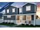 Two-story home with gray siding, rocking chairs on porch, and landscaping at , Aurora, CO 80019