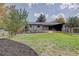 Spacious backyard with grassy area and mature trees at 12445 W 19Th Pl, Lakewood, CO 80215