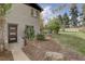 Landscaped backyard with a pathway leading to a private entrance at 12445 W 19Th Pl, Lakewood, CO 80215