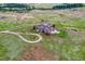 Aerial view of a luxurious home with large yard and circular driveway at 1820 S State Highway 83, Franktown, CO 80116