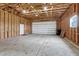 Large unfinished garage with concrete floor and overhead door at 1820 S State Highway 83, Franktown, CO 80116