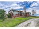 Brick house with large windows and a paved driveway at 1820 S State Highway 83, Franktown, CO 80116
