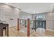 Elegant staircase with wood railing and light hardwood floors at 1820 S State Highway 83, Franktown, CO 80116