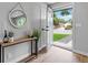 Bright entryway with wood floors, console table, and round mirror at 7946 Joan Dr, Denver, CO 80221