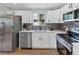 Updated kitchen with stainless steel appliances and white cabinetry at 7946 Joan Dr, Denver, CO 80221