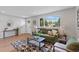 Living room with green sofa, wood floors, and geometric rug at 7946 Joan Dr, Denver, CO 80221