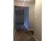 Carpeted hallway leading to living area at 7695 E Quincy Ave # 102, Denver, CO 80237