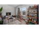 Living room with stone fireplace, hardwood floors, and a Christmas tree at 6576 S Teller Ct, Littleton, CO 80123