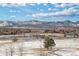 Community park view with a serene pond and snow-dusted landscape and mountain backdrop at 6576 S Teller Ct, Littleton, CO 80123