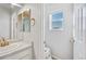 Bathroom with gold fixtures, single vanity, and a window providing natural light at 4780 N Kalispell St, Denver, CO 80239