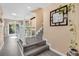 Modern staircase with gray flooring and white railing at 7360 E Hinsdale Ave, Centennial, CO 80112