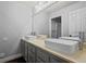 Modern bathroom with double sinks and gray cabinets at 17085 W 62Nd Cir, Arvada, CO 80403