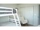 Bedroom with a bunk bed, a rocking chair, and a sliding door closet at 9841 E 56Th Pl, Denver, CO 80238