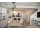 Modern kitchen with white cabinets, stainless steel appliances, and an island with seating at 9841 E 56Th Pl, Denver, CO 80238