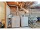 Basement laundry area with washer, dryer, and utility sink at 3440 Newton St, Denver, CO 80211