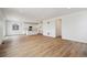 Open living room with light brown laminate flooring and kitchen view at 4599 Boone Cir, Brighton, CO 80601