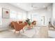 Virtually staged living room with orange accent chairs at 20968 E 60Th Pl, Aurora, CO 80019