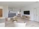 Bright living room with hardwood floors, comfy seating, and a large TV at 13722 Legend Way # 101, Broomfield, CO 80023