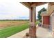 Patio with view of open space and distant homes at 13722 Legend Way # 101, Broomfield, CO 80023