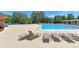 Community pool with lounge chairs and surrounding landscaping at 13722 Legend Way # 101, Broomfield, CO 80023