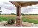 Patio with view of open space and distant homes at 13722 Legend Way # 101, Broomfield, CO 80023
