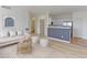 Open living room showcasing a modern aesthetic and partial kitchen view at 13722 Legend Way # 101, Broomfield, CO 80023