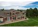 Rear view of two-story home with balcony and patio at 13722 Legend Way # 101, Broomfield, CO 80023