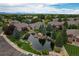 Aerial view of a community with houses, pond, and landscaping at 13722 Legend Way # 101, Broomfield, CO 80023