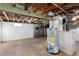 Unfinished basement with water heater and storage shelves at 203 W Rafferty Gardens Ave, Littleton, CO 80120