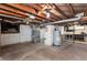 Unfinished basement with HVAC system, water heater, and storage shelves at 203 W Rafferty Gardens Ave, Littleton, CO 80120