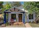 Charming white home with blue trim, porch swing, and landscaped front yard at 203 W Rafferty Gardens Ave, Littleton, CO 80120