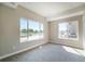 Well-lit bedroom with large windows and carpeted floor at 8500 W 62Nd Ave # H, Arvada, CO 80004