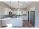 Modern kitchen with white cabinets, stainless steel appliances, and quartz countertops at 8500 W 62Nd Ave # H, Arvada, CO 80004