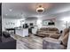 Open living room and kitchen with wood floors and neutral tones at 802 Eva Peak Dr, Erie, CO 80516