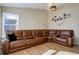 Living room featuring a large brown sectional sofa and hardwood floors at 5305 Willow Ct, Castle Rock, CO 80104