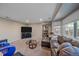 Living room features a large TV, comfortable seating, and a bay window at 11026 Callaway Rd, Parker, CO 80138