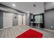 Finished basement recreation room with gray walls, wood-look flooring and large closets at 11026 Callaway Rd, Parker, CO 80138